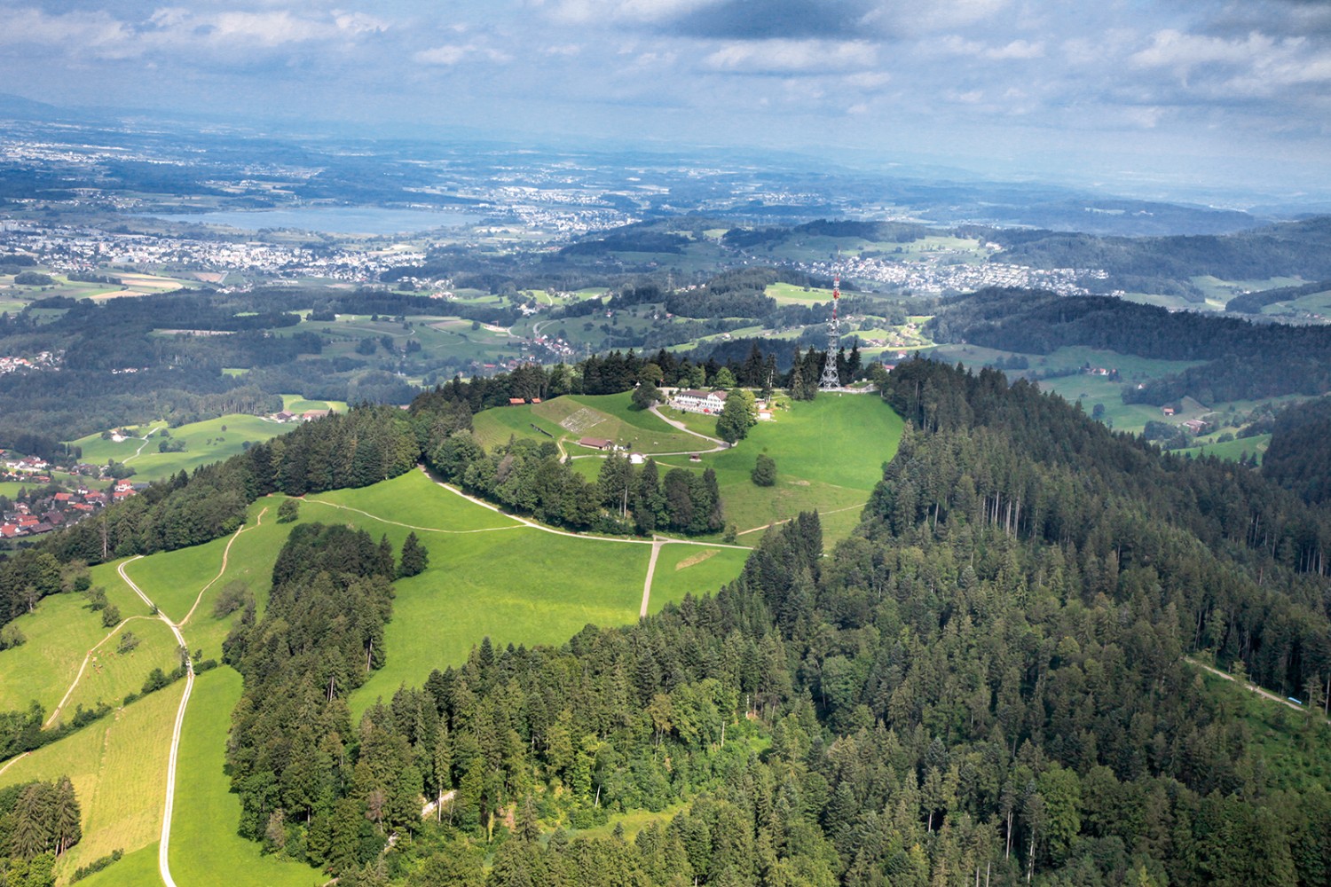 Photo aérienne du Bachtel. Depuis la tour, la vue sur Wetzikon et le lac de Pfäffikon est tout aussi magnifique. Photo: Wiget Foto, Wald